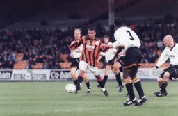 Kim Grant manages to get away from a possee of Vale defenders