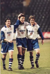 Steve Davis celebrates with the goalscorers Ceri Hughes and Graham Alexander as the Town get back to winning ways
