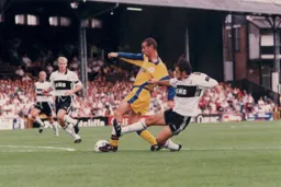 Simon Davies' progress is halted on the edge of the penalty area