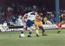 A defender grabs a handful of Tony Thorpe`s shirt