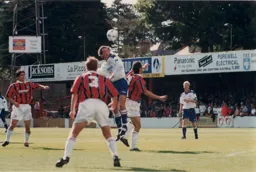 Paul McLaren gets above Franck Rolling to win a header