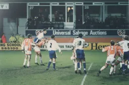 Steve Davis in typical fashion wins a header in a crowded penalty area