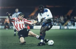 A sliding tackle dispossesses Mitchell Thomas