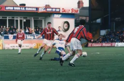 Gary Waddock is at full stretch to win the ball