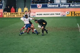 Aiden Davison gathers the ball as Dwight Marshall rushes in