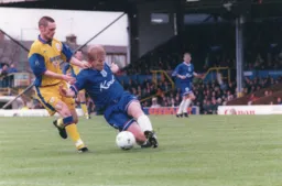 Adrian Pennock gets in a sliding tackle to stop Graham Alexander