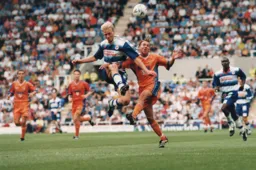 Liam George is beaten to a header