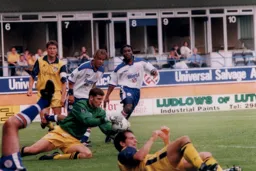Liam George and Stuart Douglas watch on as the keeper saves