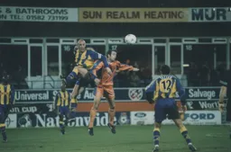 Ray McKinnon in an aerial battle with Gary McAllister