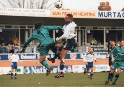 Liam George rising for a header