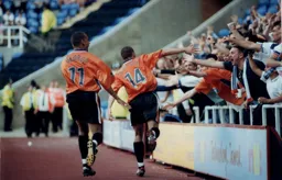 The Town's goalscorers Fotiadis and George celebrate the with the travelling Hatters