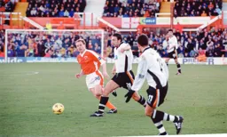 Adam Locke beats Kevin Richardson to the ball