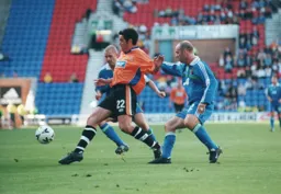 Dean Brennan gets in for the ball before Darren Sheridan