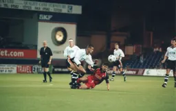 Peter Thomson gets stuck in to some midfield action