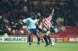 Emmerson Boyce keeps a close watch on Kevin Phillips
