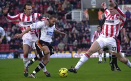 Frode Kippe moves in to tackle Liam George