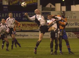 Marvin Johnson gets stuck in to Brian Atkinson