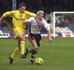 Petri Helin gets one in the neck from Joe Dunne