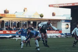 Matt Taylor heads the ball forward