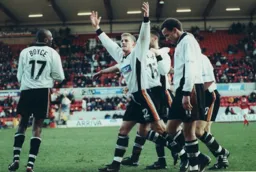 Lee Mansell arms aloft after scoring the third goal