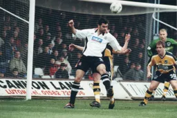 Julian Watts wins a header in the Rovers penalty area