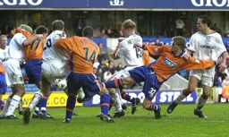 A scramble in the Millwall penalty area with Lee Mansell trying to force the ball through