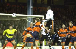 Emmerson Boyce sends a header towards goal