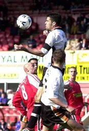 Julian Watts heads the ball clear