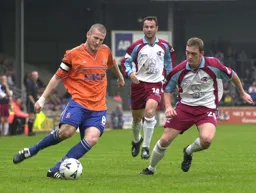 Kevin Nicholls chips the ball forward