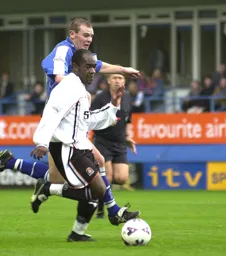A determined Adrian Forbes drives forwards