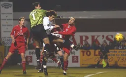 Jean-Louis Valois is sandwiched between Kiddy defenders