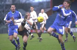 Dean Crowe tries to play the ball forward