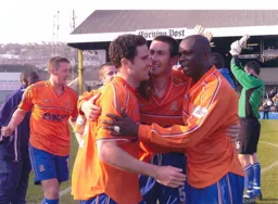 Stalwart defenders Chris Coyne, Russell Perrett and Marvin Johnson in a huddle at the end