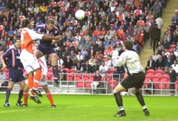 Steve Howard heads towards goal