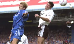 Russ Perrett goes up for the ball