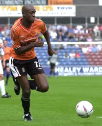 Emmerson Boyce comes away with the ball