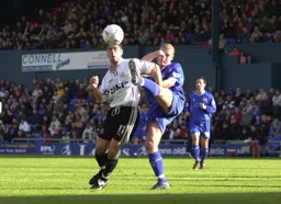 Steve Robinson tries to avoid the defenders high foot