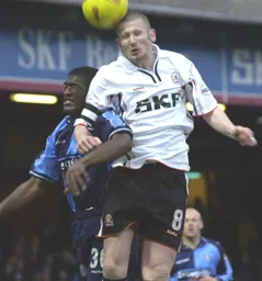 Kevin Nicholls wins the header