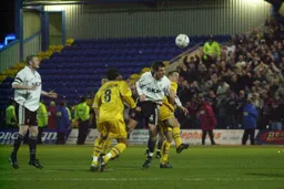 Matthew Spring heads the ball forwards