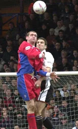 Chris Coyne contests a header