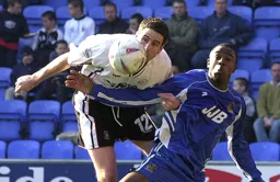 Chris Coyne challenges for the ball