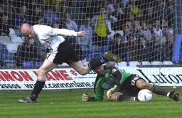 Paul Hughes hurdles the goalkeeper