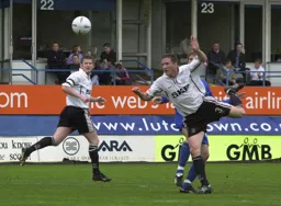 Alan Neilson heads the ball on
