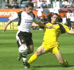 Tony Thorpe knocks the ball past Andy Edwards
