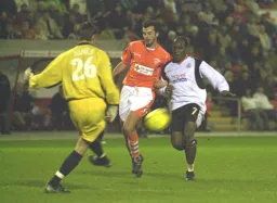 Adrian Forbes run at goal is thwated by Brad Jones