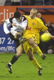 Steve Robinson gets a shot off under pressure by Fraser McLachlan