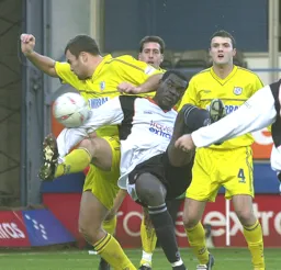 Enoch Showunmi is tightly marked