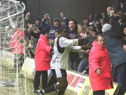 Enoch Showunmi celebrates with the fans after scoring the third goal