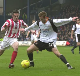 Peter Holmes arms out stretched brings the ball forward