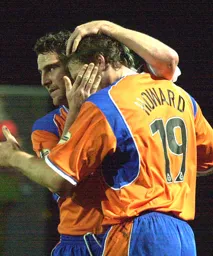 Chris Coyne congratulates Steve Howard after scoring the first goal